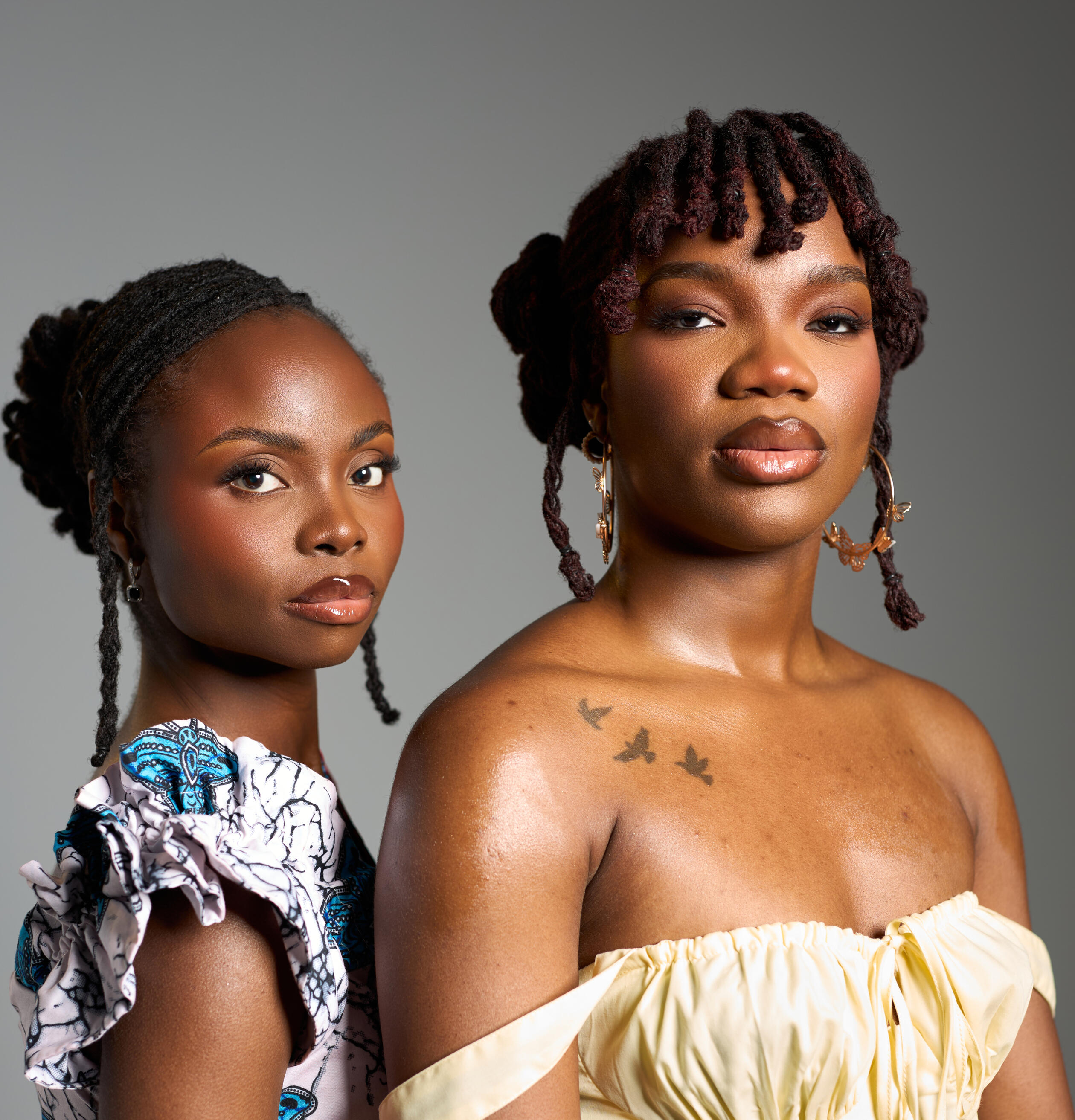 2 women with locs looking into the camera
