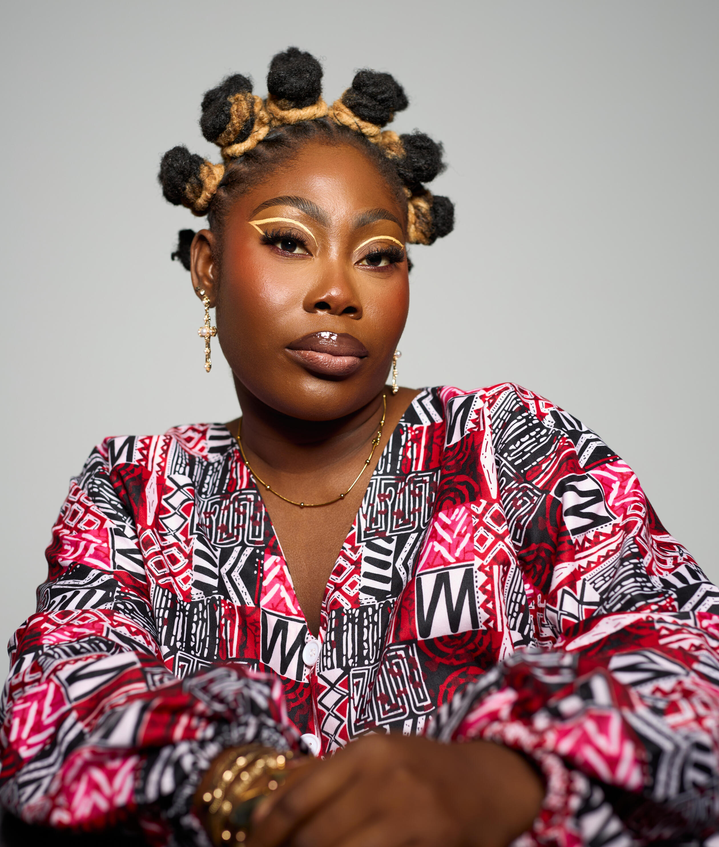 1 woman with locs, looking into the camera